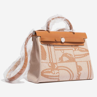 Hermès Herbag Zip Backpack 31 Gold / Ecru side view